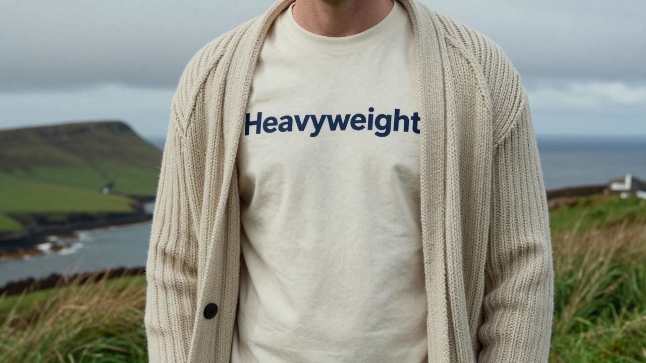 A person wearing a heavyweight T-shirt under a chunky Irish knit sweater outdoors.