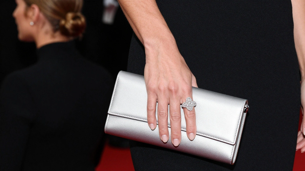Close-up of a cocktail ring and sleek clutch paired with a black evening dress