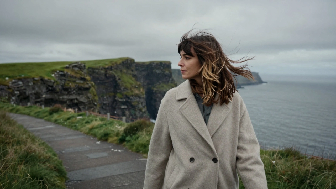 Woman with layered hair walking along windy Irish coastal cliffs
